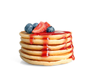 Stack of pancakes with berries and syrup on white background