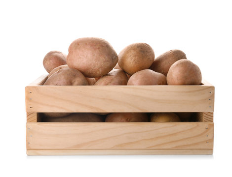 Wooden crate with fresh ripe organic potatoes on white background