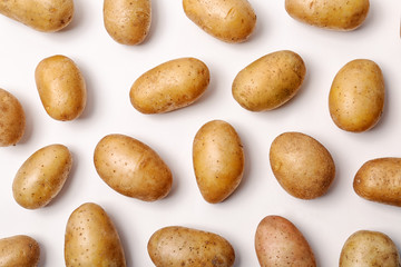 Flat lay composition with fresh organic potatoes on white background