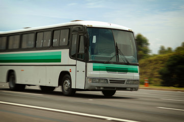 Fototapeta na wymiar speeding old white and green striped bus