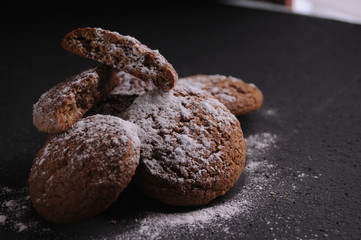 oatmeal cookies on a black table in castor sugar