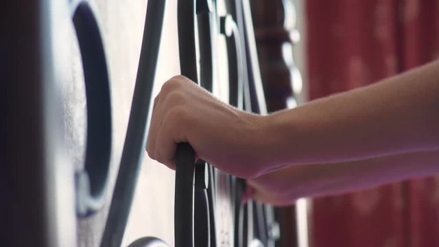 women's hands clinging to the forged head of the bed. forged beds, details. 4k, slow motion.