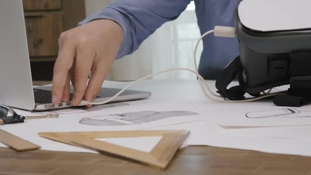 Close-up software engineer programming VR headset