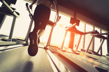 Exercise treadmill cardio running workout at fitness gym of woman taking weight loss with machine aerobic for slim and firm healthy in the morning.