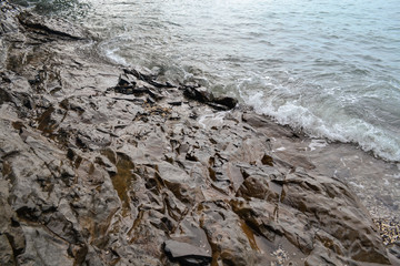 the waves of the sea reach the rocks
