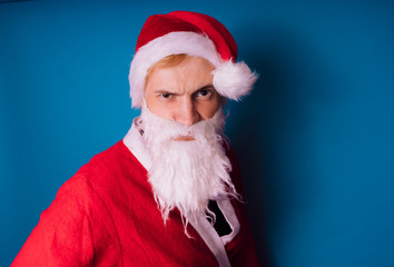 Santa Claus on a blue background. Happy New Year and merry Christmas!