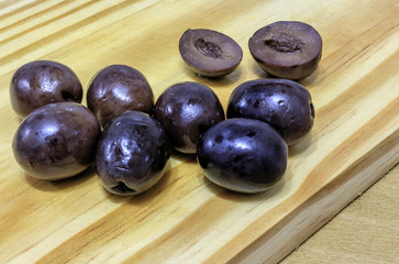 Black olives on wooden board