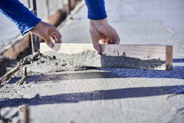 A mason leveling a Cement Slab