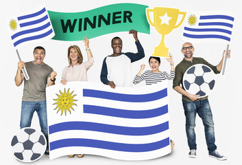 Diverse football fans holding the flag of Uruguay
