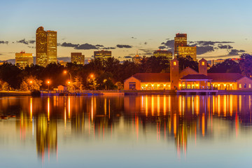 City Park at Dusk - A summer evening view of Ferril Lake in Denver City Park, with city skyline in the background, at east-side of Downtown Denver, Colorado, USA.