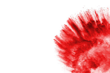 Freeze motion of red powder exploding, isolated on white background. Abstract design of red dust cloud. Particles explosion screen saver, wallpaper
