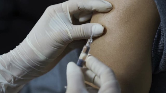 close-up nurse giving a vaccine for a patient