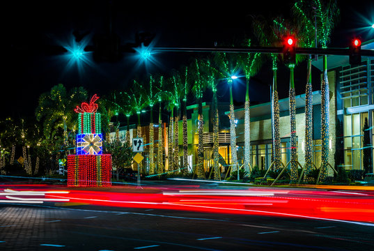 Abstract Red Light Streaks With Christmas Lights And Presents