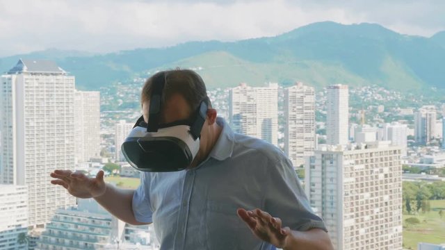 Man playing game in virtual reality glasses in Honolulu in 4k slow motion 60fps