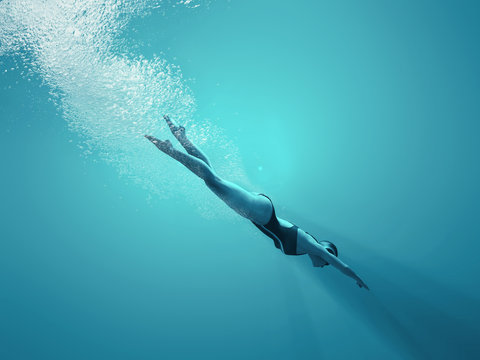 Woman Swimming Underwater In A Sea.