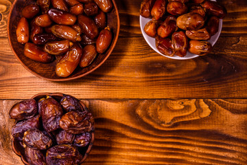 Date fruits on a wooden table. Top view