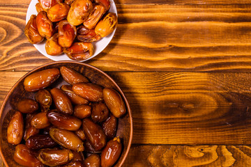 Date fruits on a wooden table. Top view