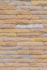 yellow stone wall  made with stone blocks