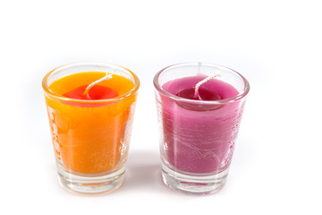 Aroma orange and pink candle in glass isolated