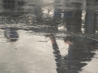 Concrete floor is not dry after pouring,Water on the concrete floor after making a smooth surface,and reflection of working construction site.