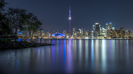 Long exposure of Toronto, Ontario - Canada. Bright sky with a smooth water surface. Beautiful city lights seen from the Toronto Island