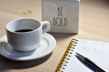 cup of coffee and pen on laptop