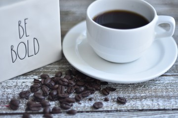 cup of coffee and beans on wooden table