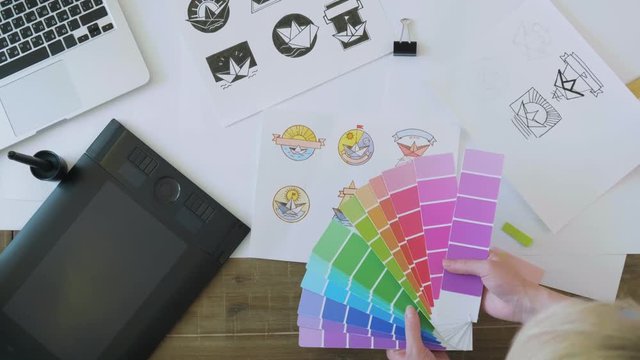 Top view graphic designers choosing a color for logo design