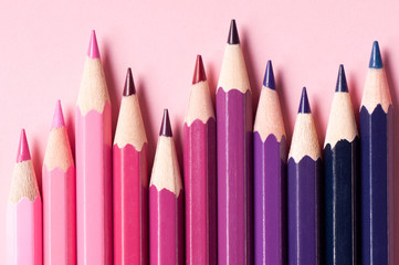 Color pencils isolated on pink background.
