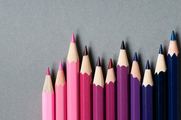 Color pencils isolated on grey background.
