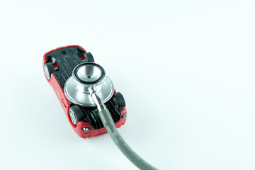 Stethoscope checking up the car on white background, Concept of car check up, repair and maintenance..