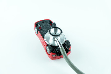 Stethoscope checking up the car on white background, Concept of car check up, repair and maintenance..