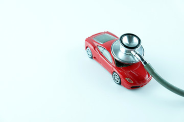 Stethoscope checking up the car on white background, Concept of car check up, repair and...
