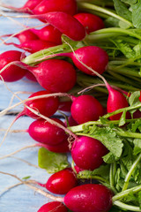 fresh radishes on wooden surface