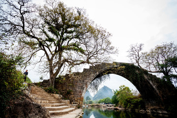 Fototapeta na wymiar Old bridge on Dragon river in Yangshuo China