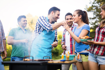 Young people grilling outdoors