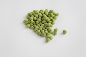 Peanuts coated with wasabi isolated on a white background