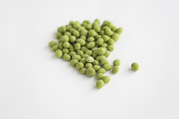 Peanuts coated with wasabi isolated on a white background