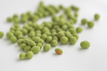 Peanuts coated with wasabi isolated on a white background