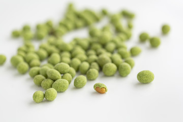 Peanuts coated with wasabi isolated on a white background