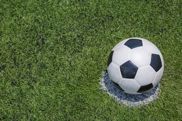 soccer ball on green soccer field grass