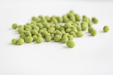 Peanuts coated with wasabi isolated on a white background