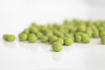 Peanuts coated with wasabi isolated on a white background