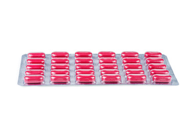 Red pills in blister with pills isolated on background