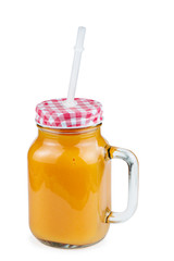 Glass jar with pumpkin smoothie and straw