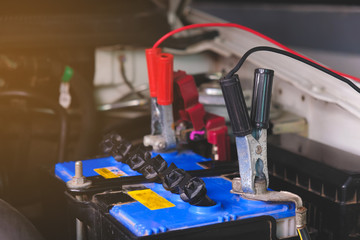 Battery charging cables transferring power , Man calling to car Mechanic service