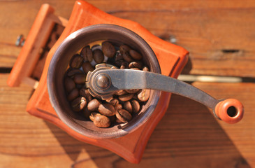 Fototapeta na wymiar A handmade coffee grinder with large coffee beans