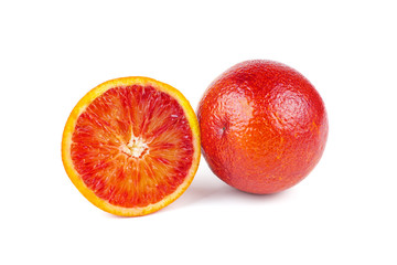 Whole and sliced bloody red oranges isolated on white background.
