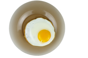 Fried egg on a glass plate isolated on white background