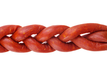 Some paprica stick-sausages on a white background